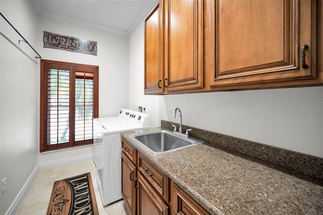 laundry room featuring separate washer and dryer, sink, and cabinets