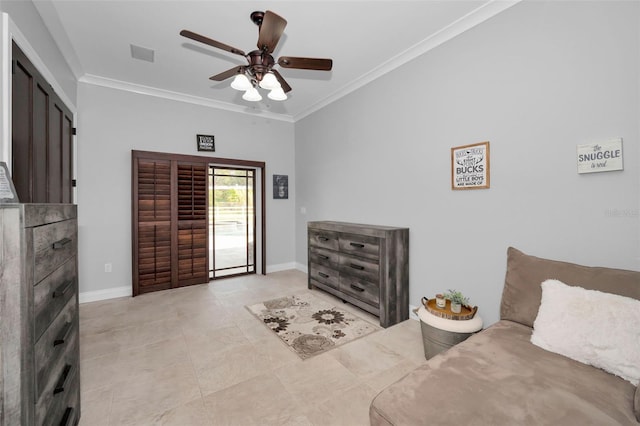 living area with ceiling fan and ornamental molding