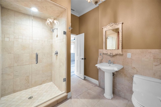 bathroom with an enclosed shower, tile patterned floors, tile walls, and toilet