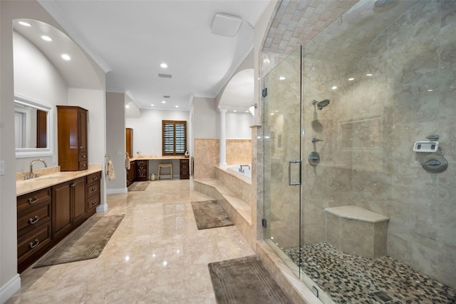 bathroom with crown molding, vanity, and shower with separate bathtub