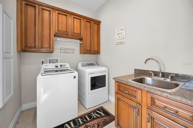 laundry room featuring sink, cabinets, and independent washer and dryer