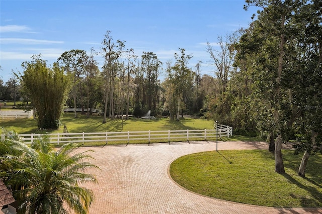 view of property's community with a yard and a rural view