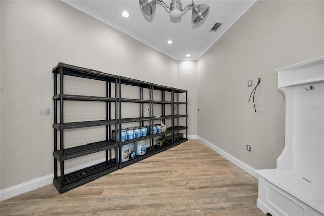 interior space with hardwood / wood-style floors, ornamental molding, and an inviting chandelier