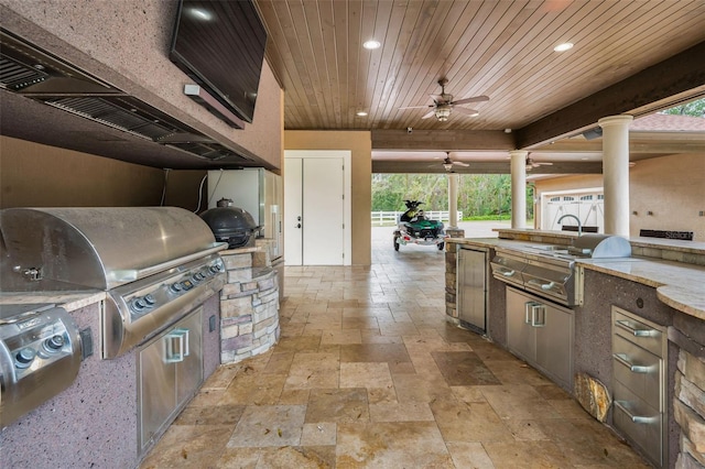 view of patio / terrace with a grill, ceiling fan, and exterior kitchen