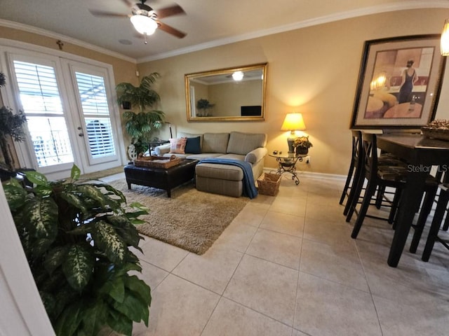 living room featuring light tile patterned floors, ceiling fan, and crown molding