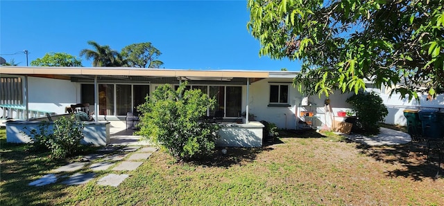 back of house with a yard