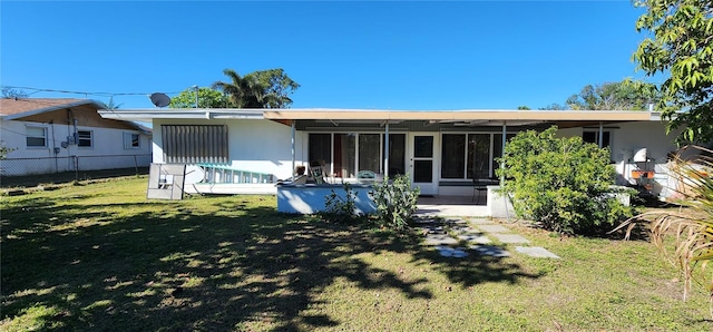 rear view of property with a lawn