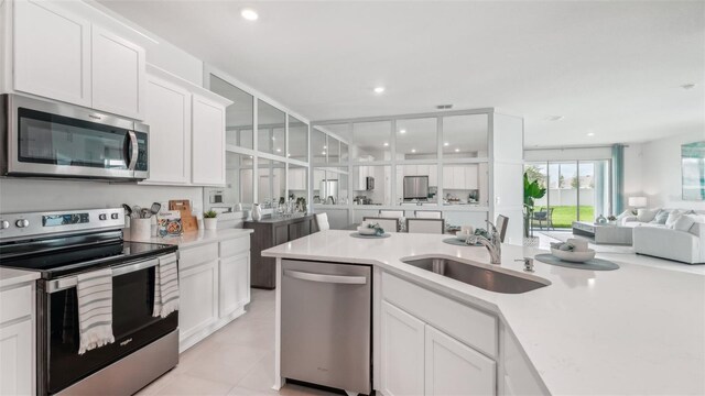 kitchen featuring white cabinetry, sink, and appliances with stainless steel finishes