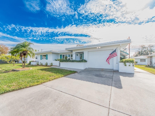 single story home featuring a garage and a front lawn