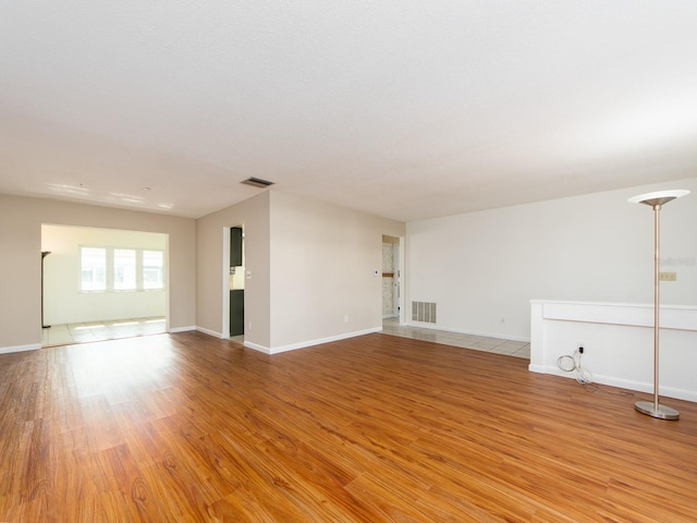 unfurnished room with light wood-type flooring