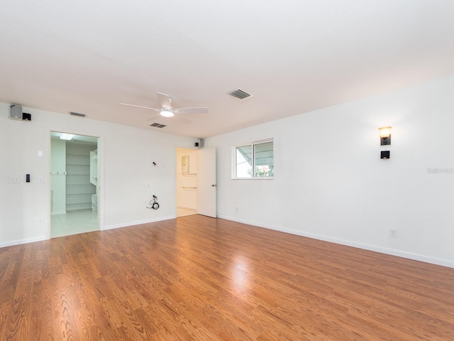 spare room featuring ceiling fan and light hardwood / wood-style flooring