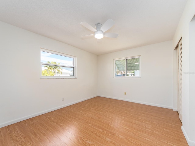 unfurnished bedroom with ceiling fan, light hardwood / wood-style floors, and a closet