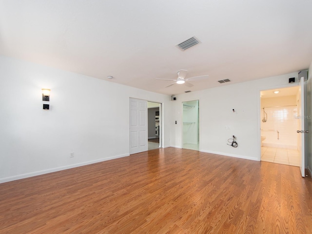 empty room featuring ceiling fan and wood-type flooring