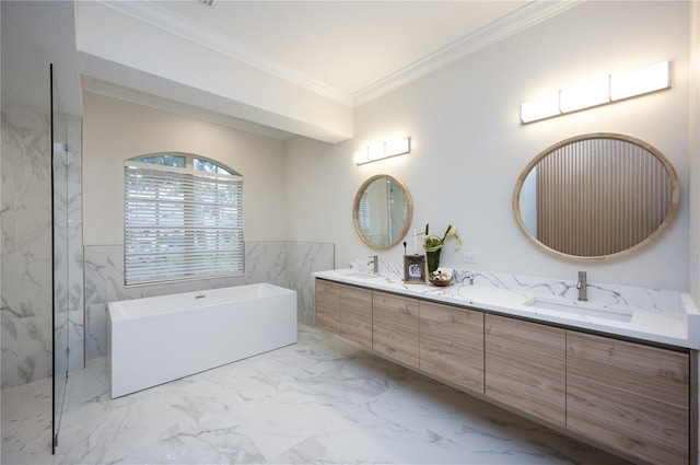 bathroom featuring vanity, crown molding, and a tub