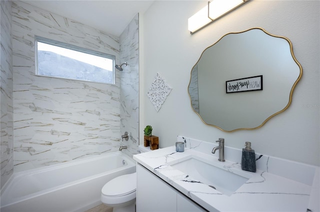 full bathroom with vanity, toilet, and tiled shower / bath