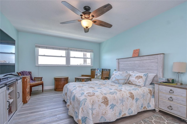 bedroom with light wood-type flooring and ceiling fan