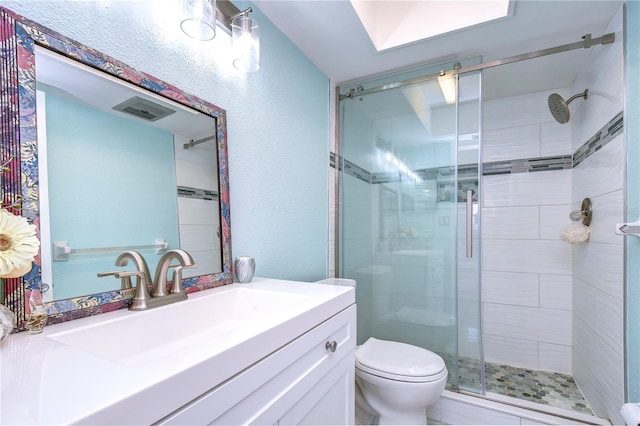 bathroom featuring vanity, an enclosed shower, and toilet