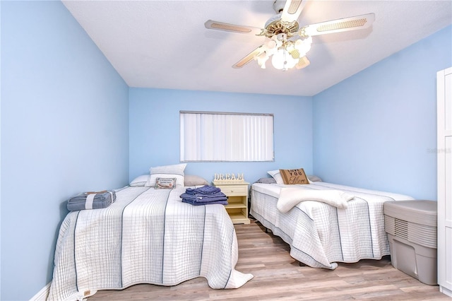 bedroom with ceiling fan and light hardwood / wood-style flooring