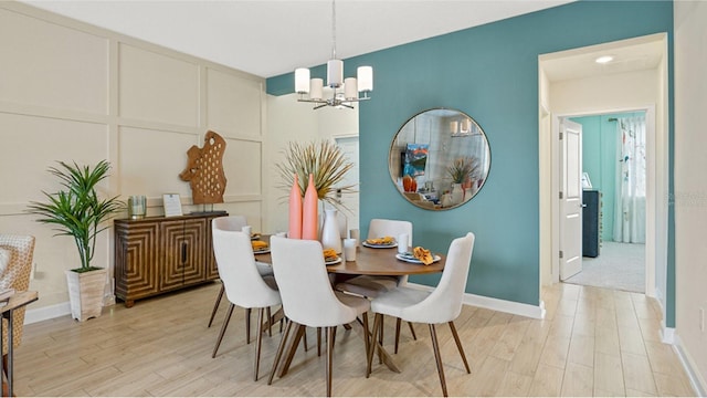 dining room featuring light hardwood / wood-style floors and an inviting chandelier