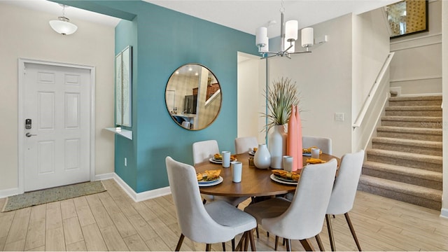 dining space featuring a notable chandelier and light hardwood / wood-style floors