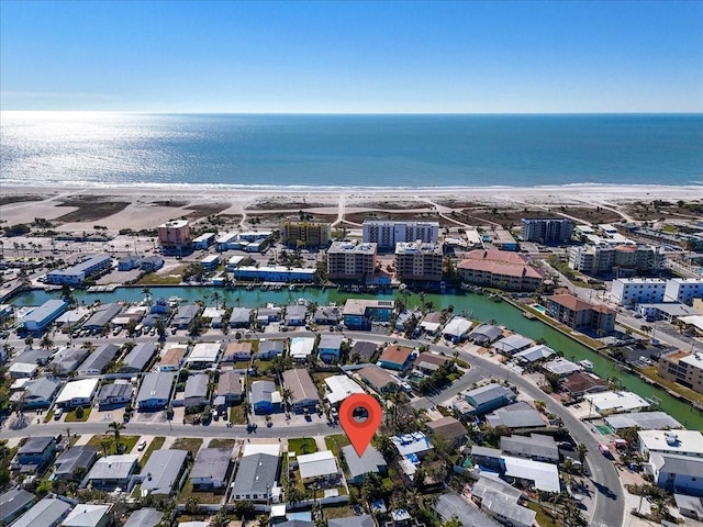 drone / aerial view with a water view and a beach view