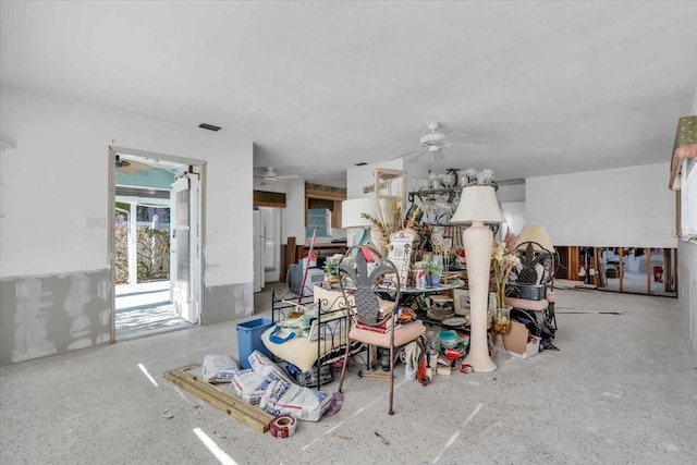 interior space with visible vents and a ceiling fan