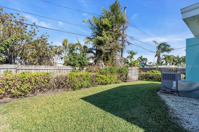 view of yard featuring central AC unit and fence private yard