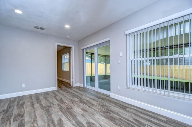 spare room with hardwood / wood-style floors