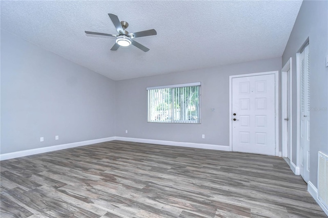 unfurnished room with ceiling fan, a textured ceiling, and hardwood / wood-style flooring