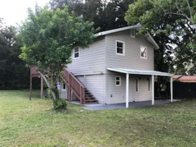 810 Ave L SW, Winter Haven, FL 33880 - rear view of house featuring a patio area, a yard, and stairs
