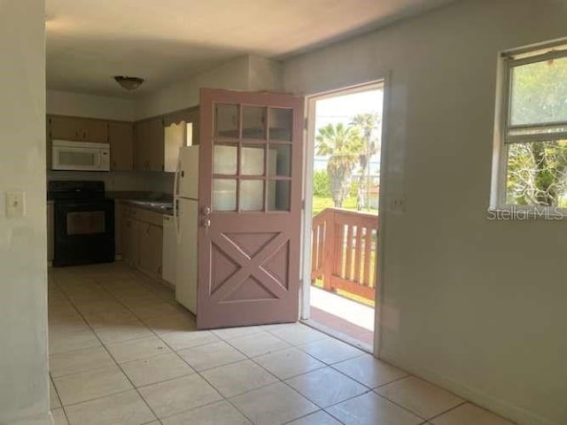 kitchen with light tile patterned floors and white appliances