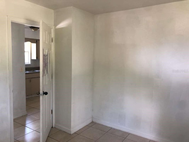 empty room with light tile patterned flooring