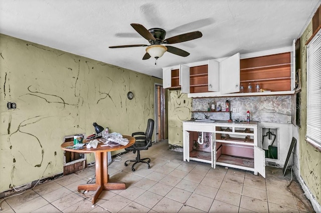 kitchen featuring white cabinets, ceiling fan, and light tile patterned floors