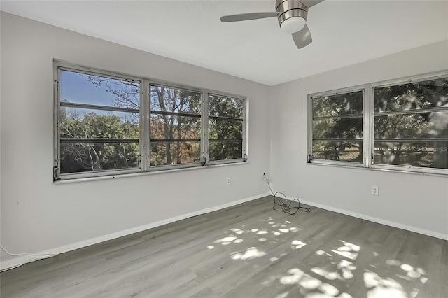 empty room featuring ceiling fan and dark hardwood / wood-style flooring