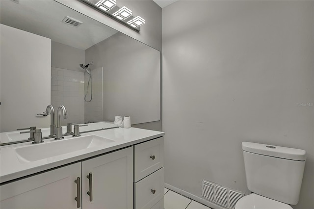 bathroom with tile patterned flooring, vanity, and toilet