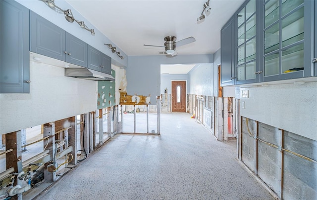 kitchen featuring ceiling fan and blue cabinetry