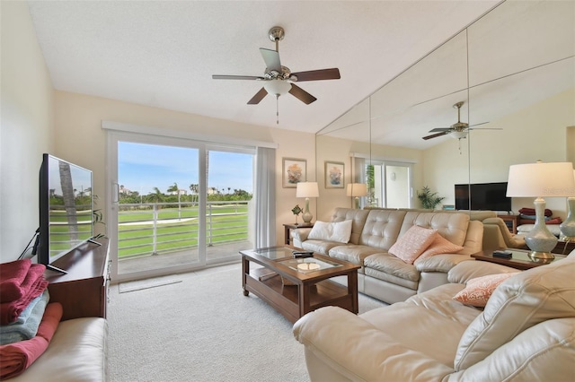 living room featuring light colored carpet, ceiling fan, and lofted ceiling