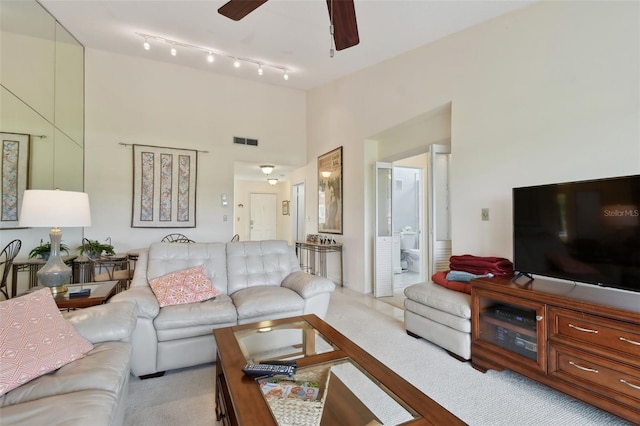 living room with light carpet and ceiling fan