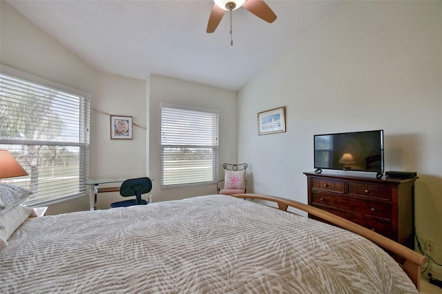 bedroom featuring multiple windows, ceiling fan, and lofted ceiling