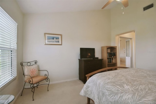 bedroom with ceiling fan and light carpet