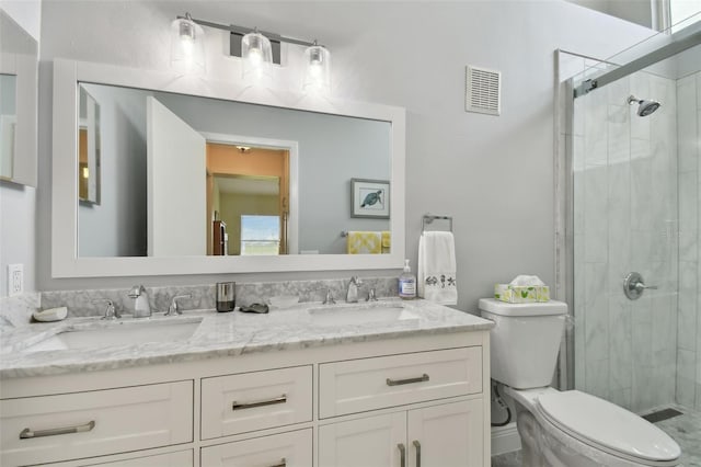 bathroom featuring vanity, toilet, and an enclosed shower