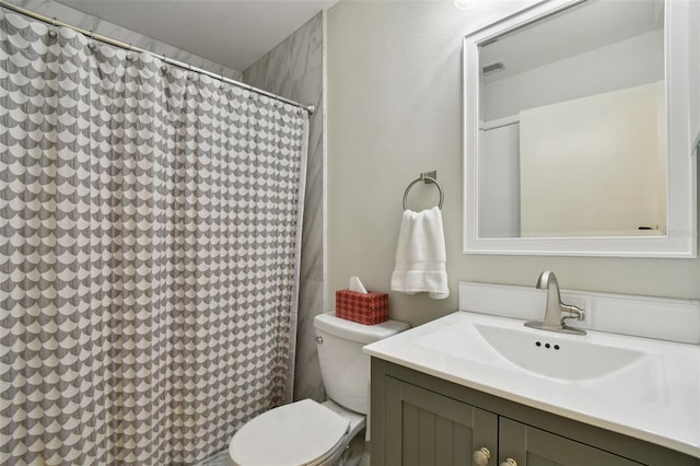 bathroom featuring vanity and toilet