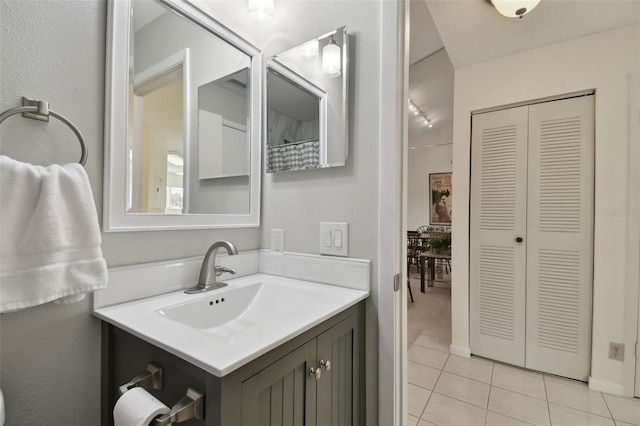 bathroom featuring a textured ceiling, vanity, and tile patterned floors