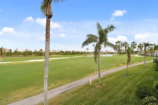 view of home's community with a water view and a yard