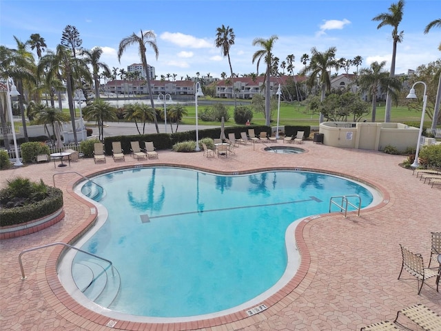 view of pool featuring a patio area and a community hot tub