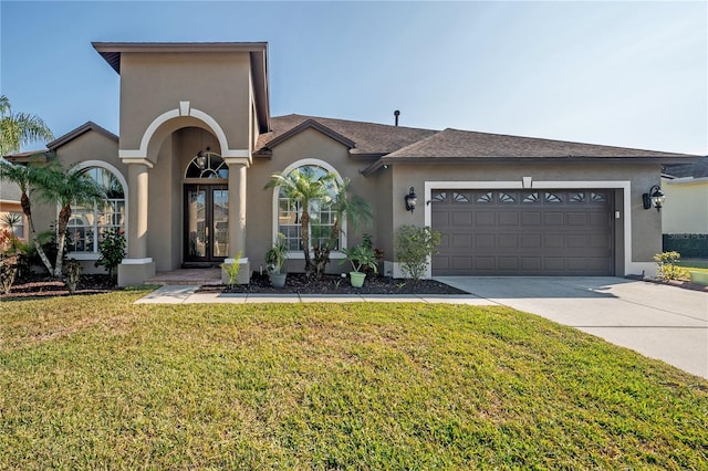 view of front of home featuring a front yard and a garage