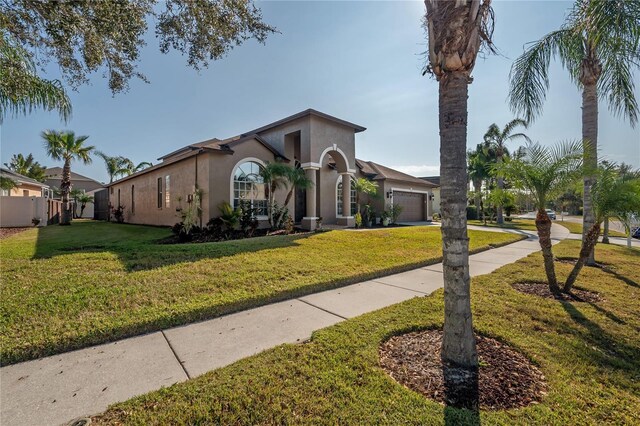 view of front of home featuring a front yard and a garage