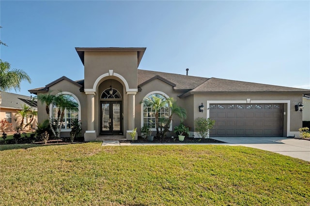 view of front of house with french doors, a front lawn, and a garage