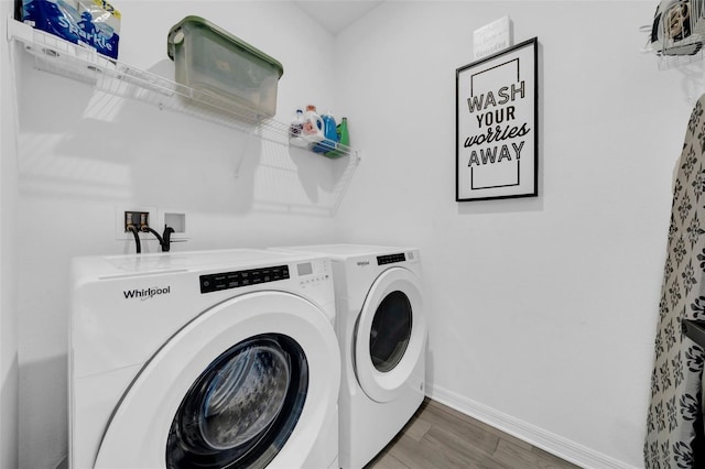 washroom featuring separate washer and dryer and dark hardwood / wood-style flooring