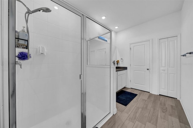 bathroom with vanity and a shower with shower door